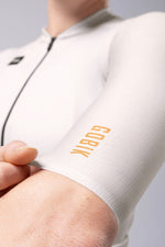 Close-up of white Gobik Infinity cycling jersey sleeve showing orange brand text
