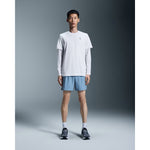 Male model wearing On 5 inch Core Shorts in light blue chambray color