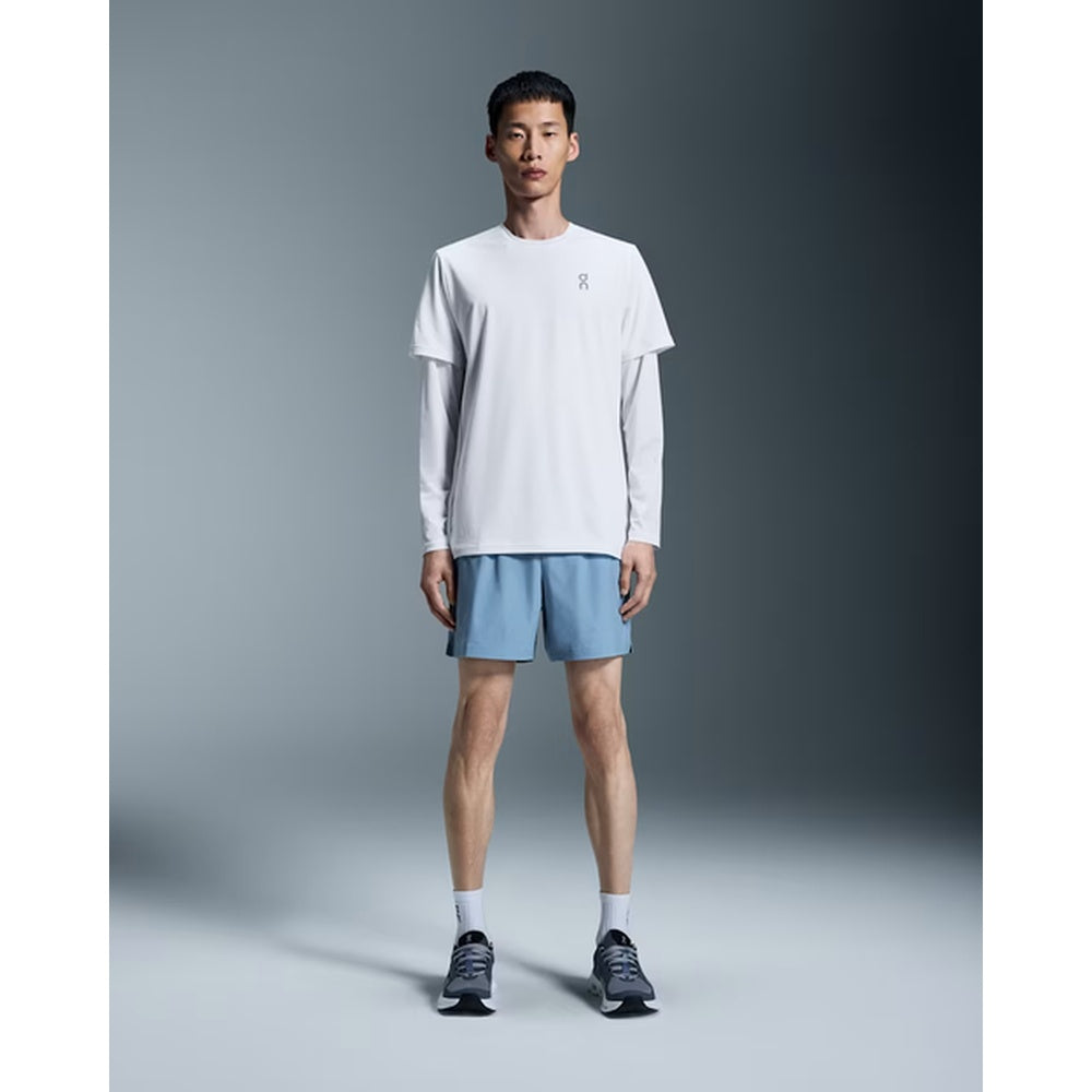 Male model wearing On 5 inch Core Shorts in light blue chambray color