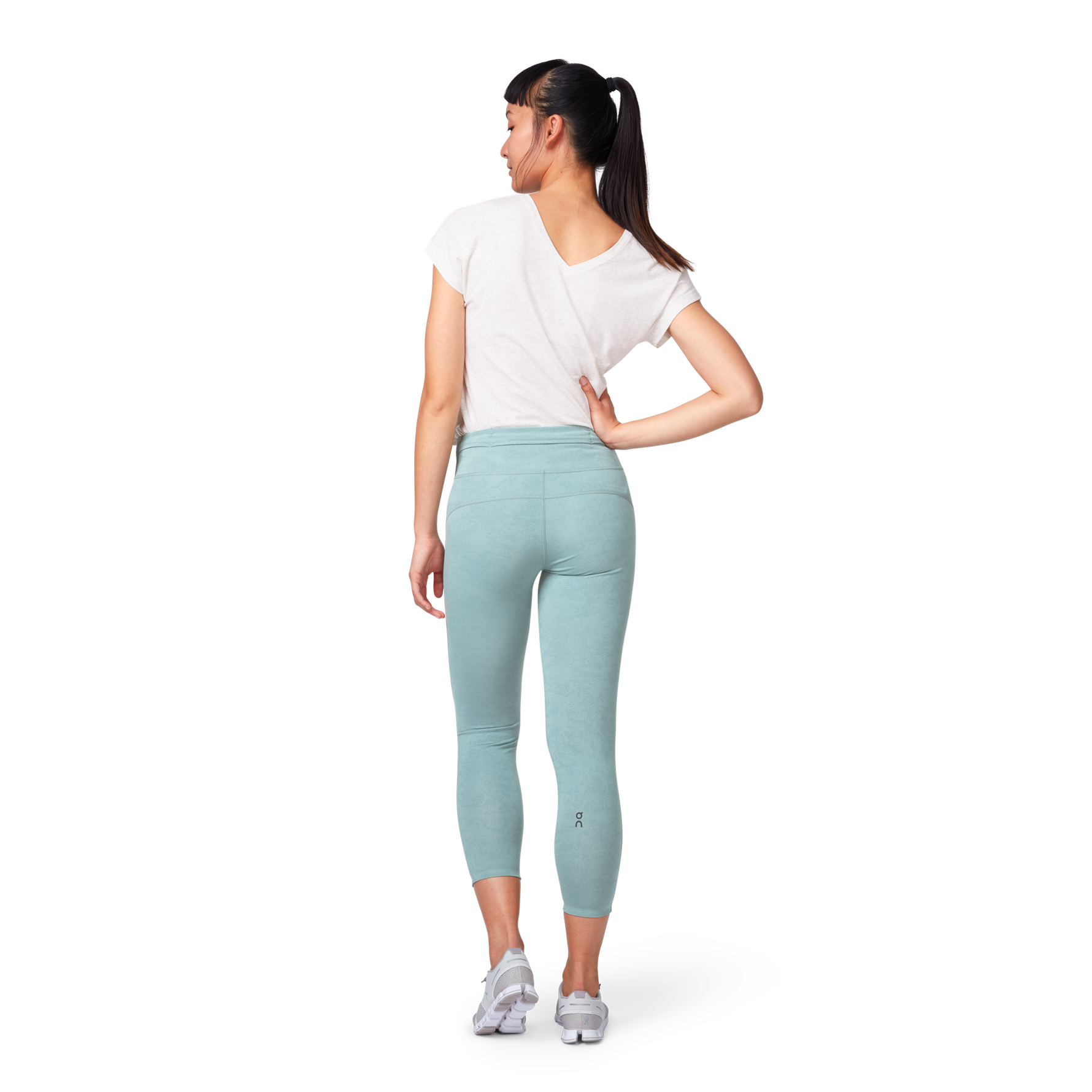 Women's On Running Tights 7/8 in sea green color, studio photo showing back view