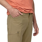 Man wearing Patagonia Quandary convertible pants in tan with hand in pocket