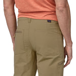 Back view of man wearing Patagonia Quandary convertible pants in classic tan color