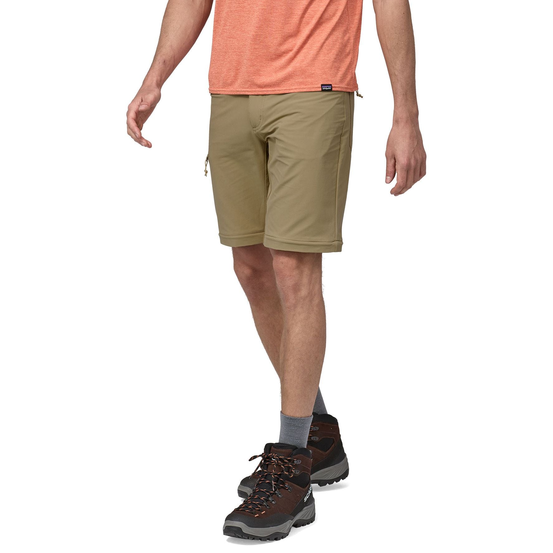 Man wearing olive green Patagonia Quandary convertible shorts with hiking boots
