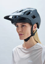 Woman wearing POC Kortal mountain bike helmet in matte gray finish