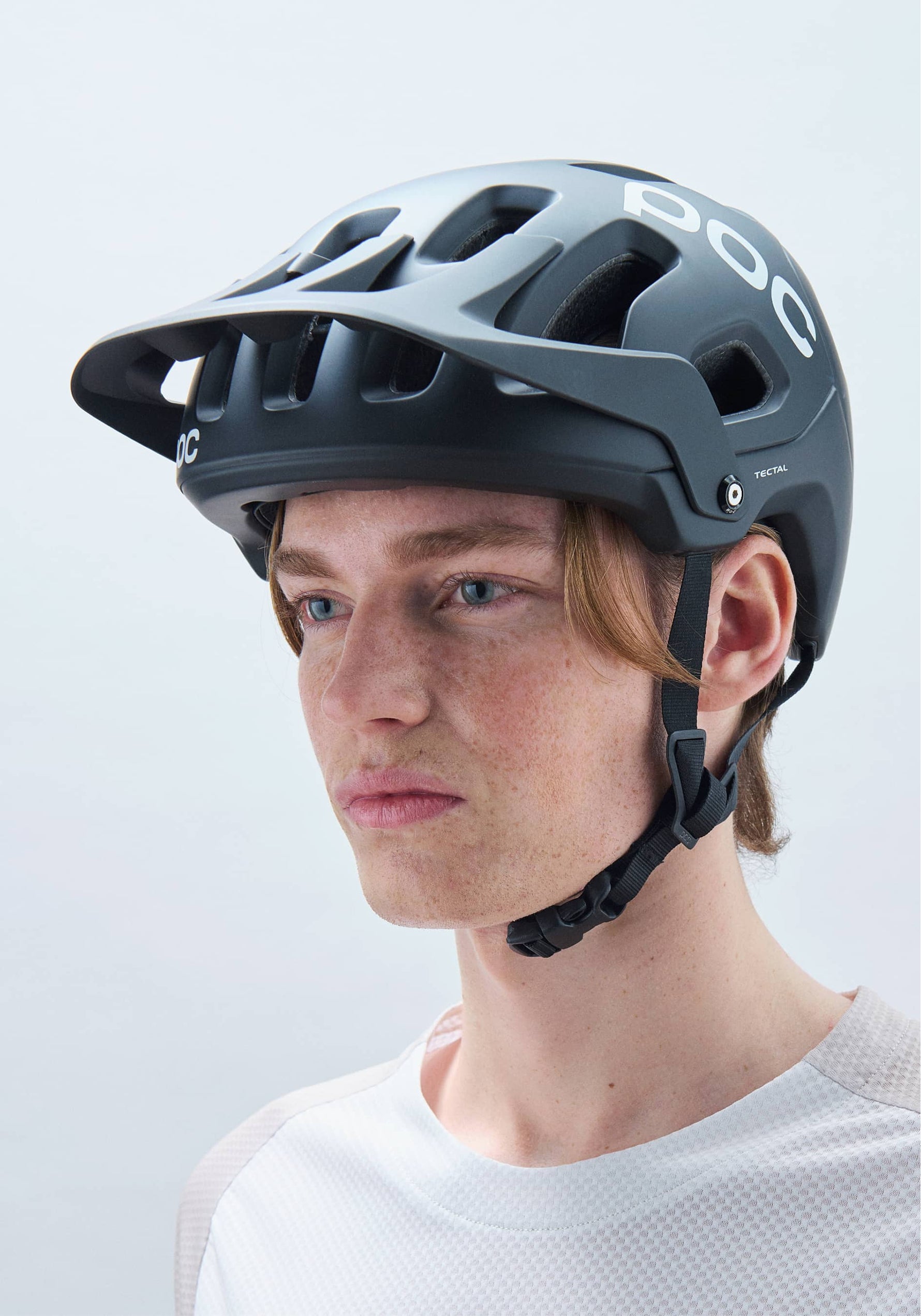 POC Tectal MTB helmet in dark gray/black worn by model on clean background