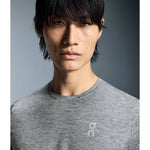 Man wearing gray heathered On Core-T athletic shirt in studio portrait