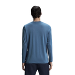 Man wearing blue On Core Long-T shirt, back view against white background