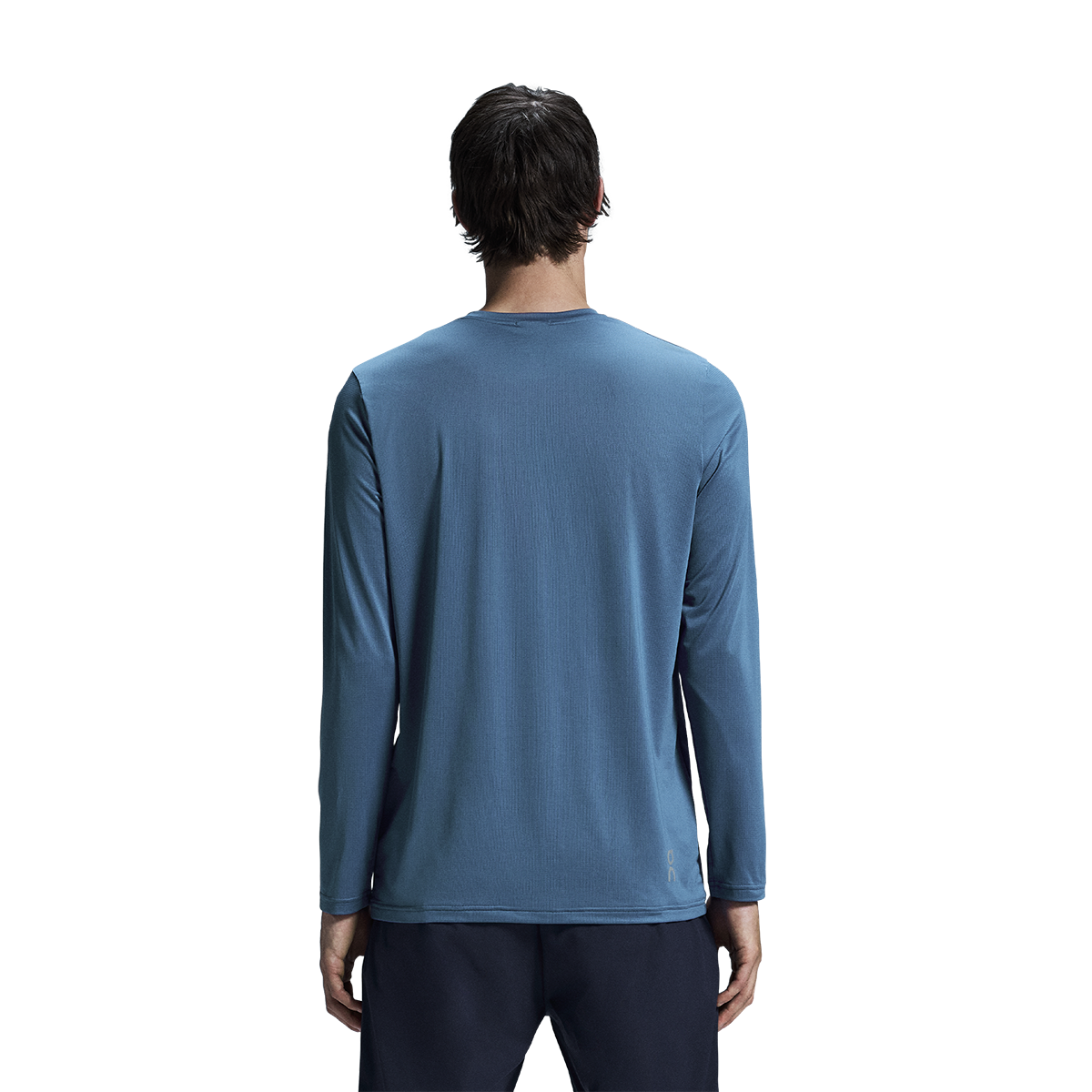 Man wearing blue On Core Long-T shirt, back view against white background