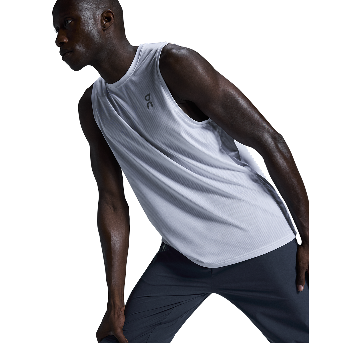 Man wearing On Core Tank in light heather gray running athletic wear