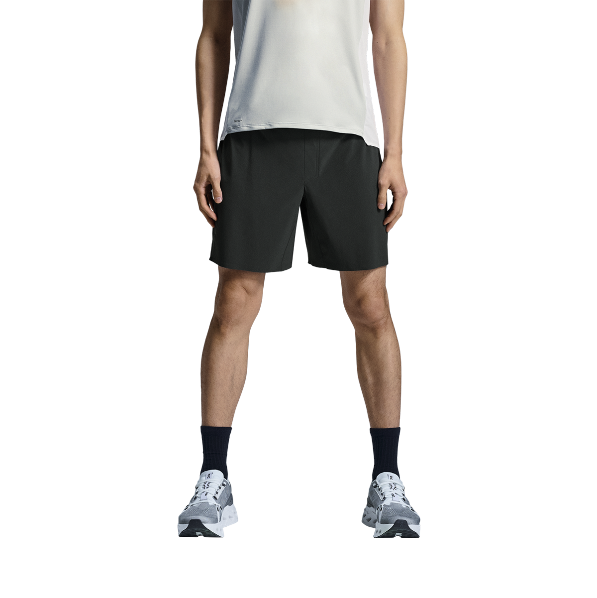 Man wearing On 5-inch lightweight running shorts in black with white tank top