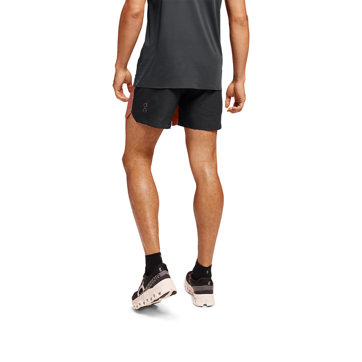 Man wearing black On 5-inch lightweight running shorts with orange accent detail