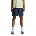 Man wearing On Focus Shorts in navy blue with light green shirt and running shoes