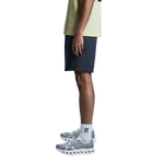 Man wearing On Focus Shorts in navy blue with matching athletic shirt and sneakers