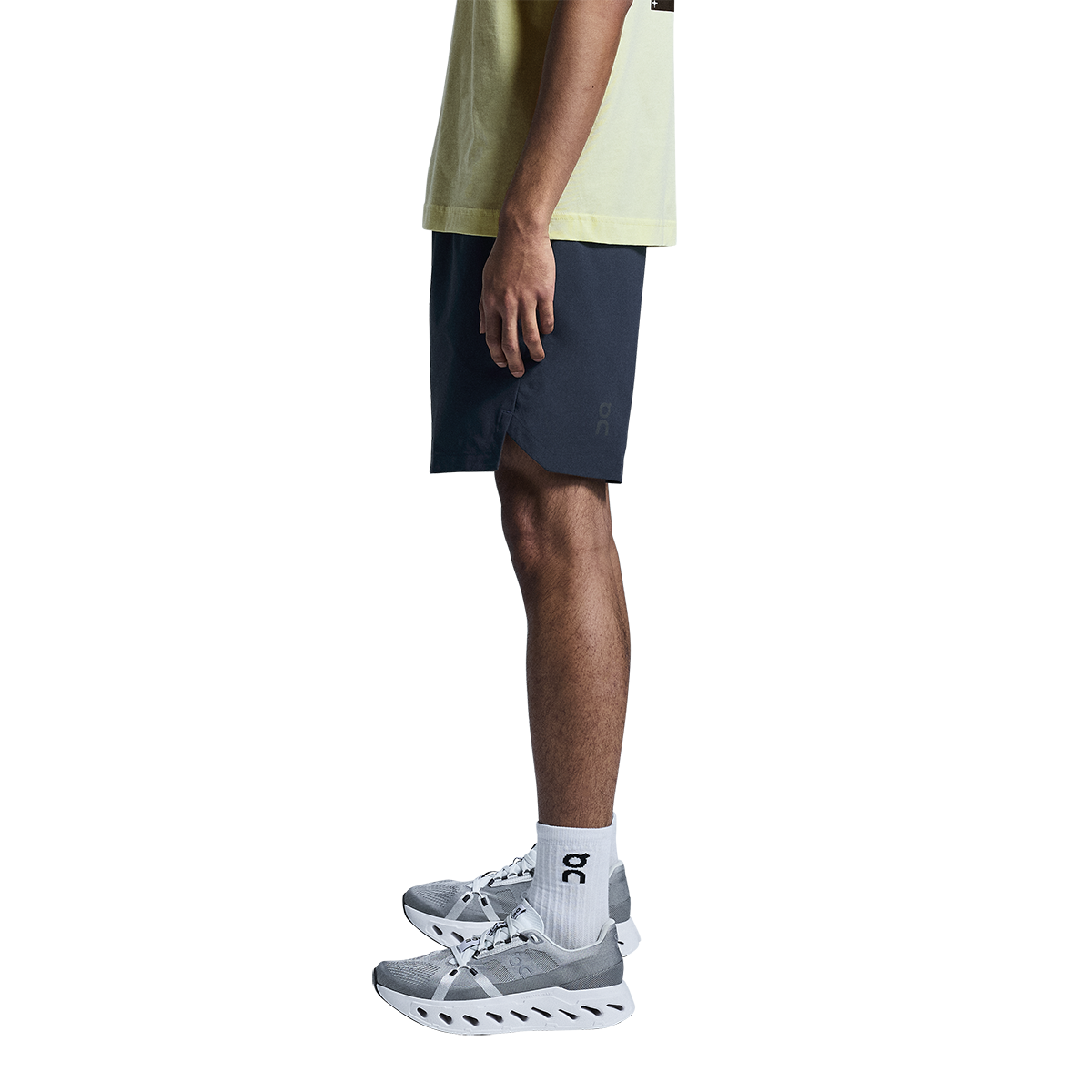 Man wearing On Focus Shorts in navy blue with matching athletic shirt and sneakers