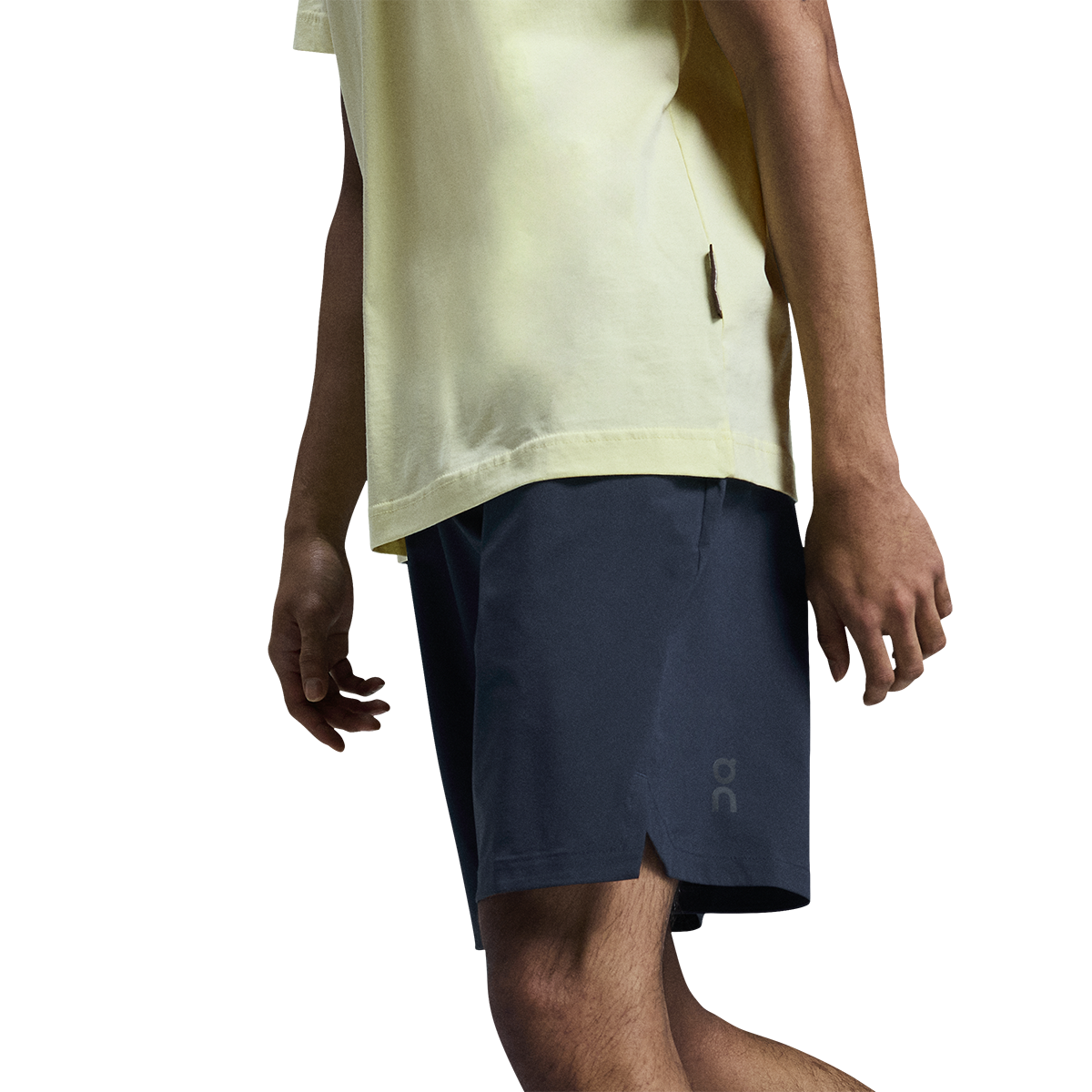Man wearing On Focus Shorts in navy blue with yellow shirt on white background