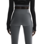 Back view of woman wearing On Studio Tights 7/8 in dark gray color