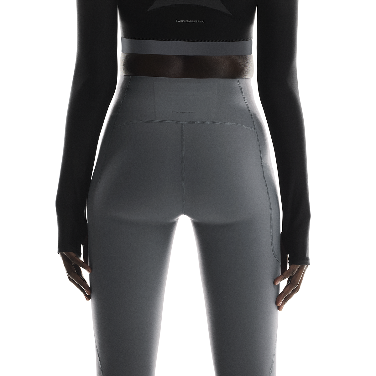 Back view of woman wearing On Studio Tights 7/8 in dark gray color
