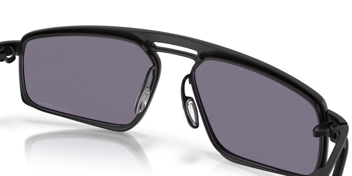 Oakley Bushwick sunglasses front close-up showing grey Prizm lenses and satin black frame detail