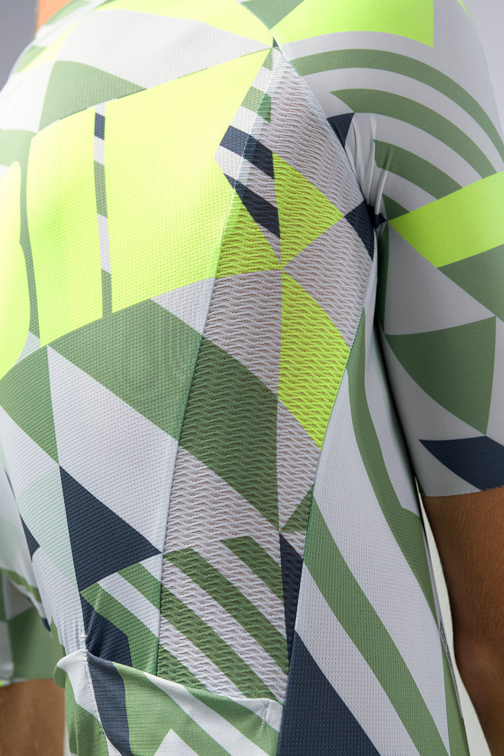 Gobik CX Pro cycling jersey close-up showing geometric pattern in green, white, and navy