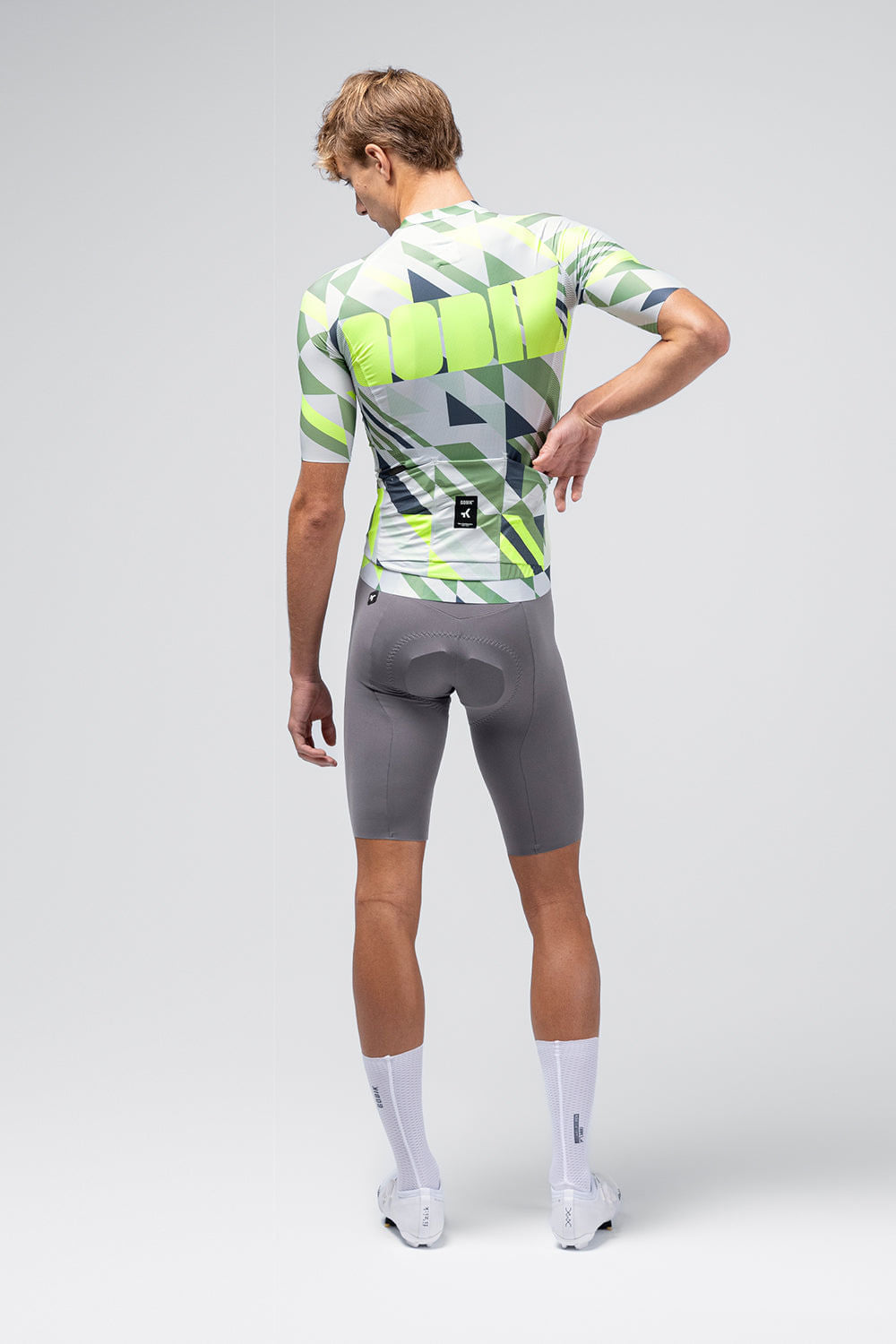 Back view of male model wearing Gobik CX Pro cycling jersey with geometric triangle pattern