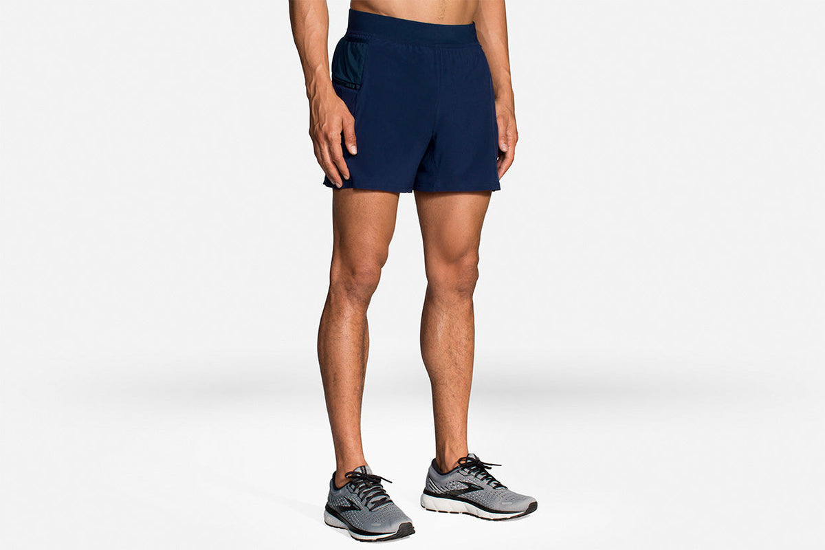 Brooks Sherpa 5-inch 2-in-1 running shorts in navy blue worn by male model