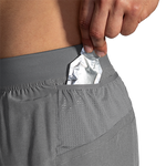 Brooks Sherpa men's running shorts with secure back pocket holding packaged item