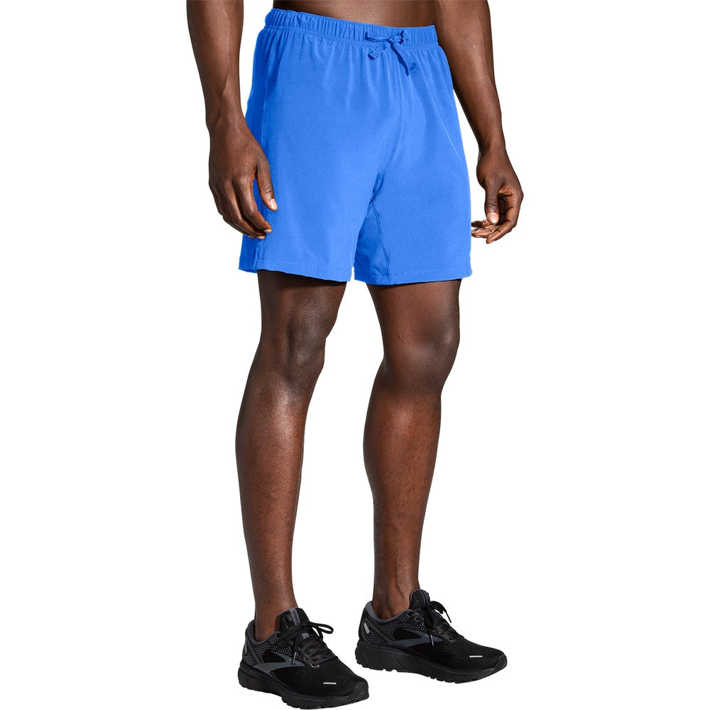 Man wearing Brooks Moment 7-inch running shorts in vivid blue with drawstring waist