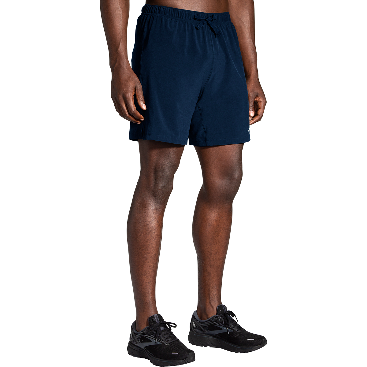 Man wearing navy blue Brooks Moment 7-inch running shorts with elastic waistband and drawstring