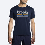 Brooks Distance Short Sleeve 2.0 in HTR Navy with colorful track stripe graphic on male model