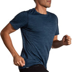 Man running in Brooks Luxe Short Sleeve shirt in heathered cerulean blue color