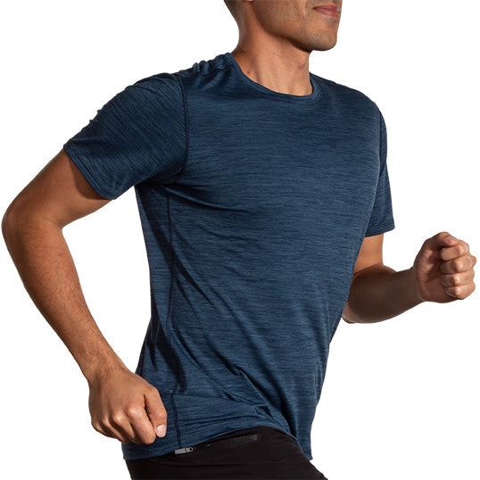 Man running in Brooks Luxe Short Sleeve shirt in heathered cerulean blue color