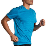 Man running in Brooks Luxe Short Sleeve shirt in heathered cerulean blue color