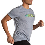 Man running wearing Brooks Distance Short Sleeve 3.0 in heather gray with logo