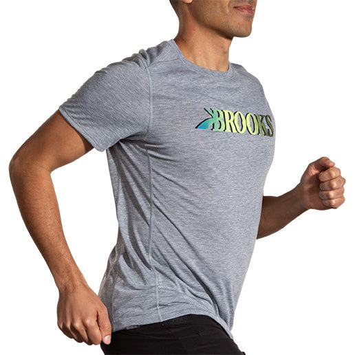 Man running wearing Brooks Distance Short Sleeve 3.0 in heather gray with logo