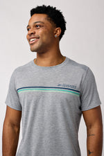 Man wearing Brooks Distance Short Sleeve 3.0 in gray with chest stripes smiling