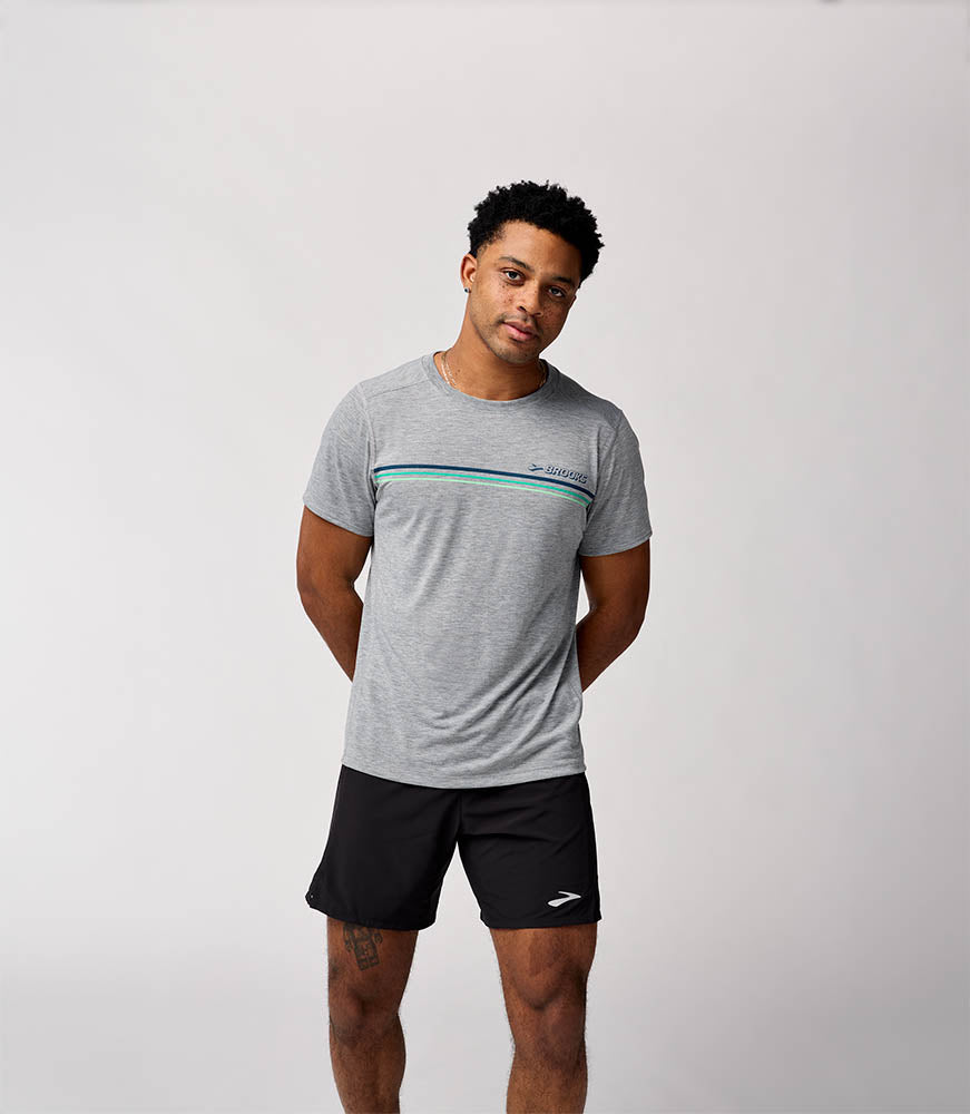 Man wearing Brooks Distance Short Sleeve 3.0 in heathered gray with chest stripe detail