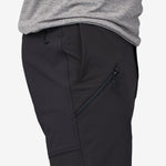 Close-up of black Patagonia trail pants showing zippered side pocket and drawstring waist