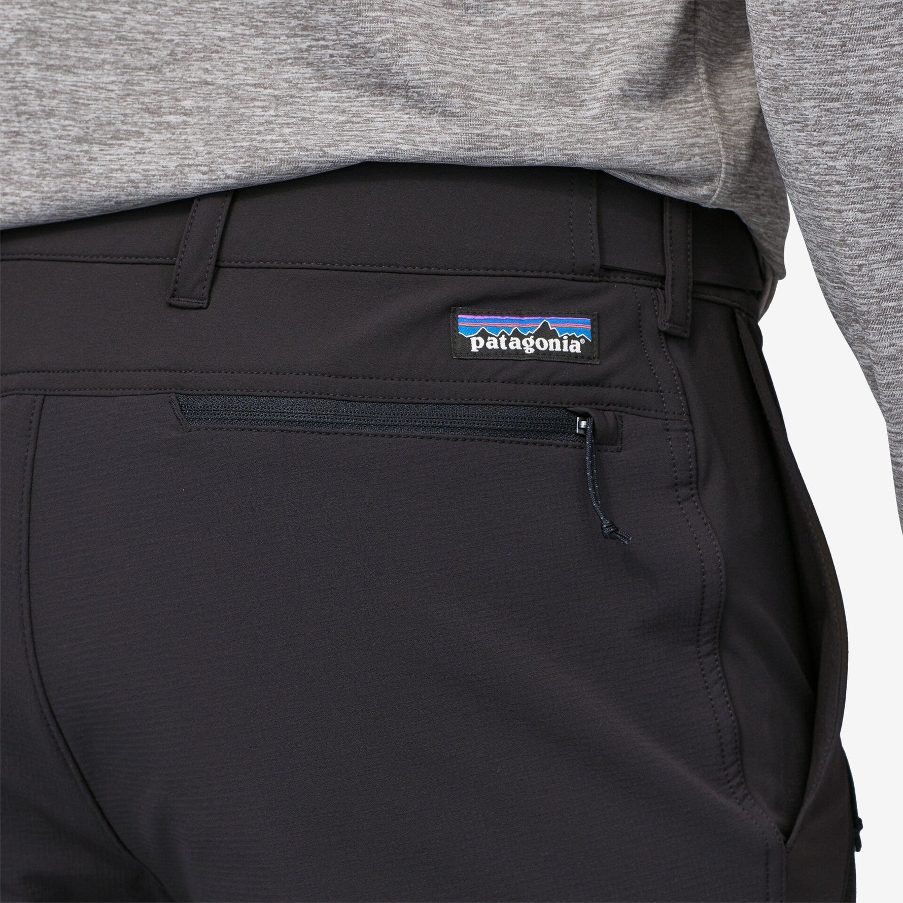 Close-up of black Patagonia Point Peak Trail Pants showing logo and pocket detail
