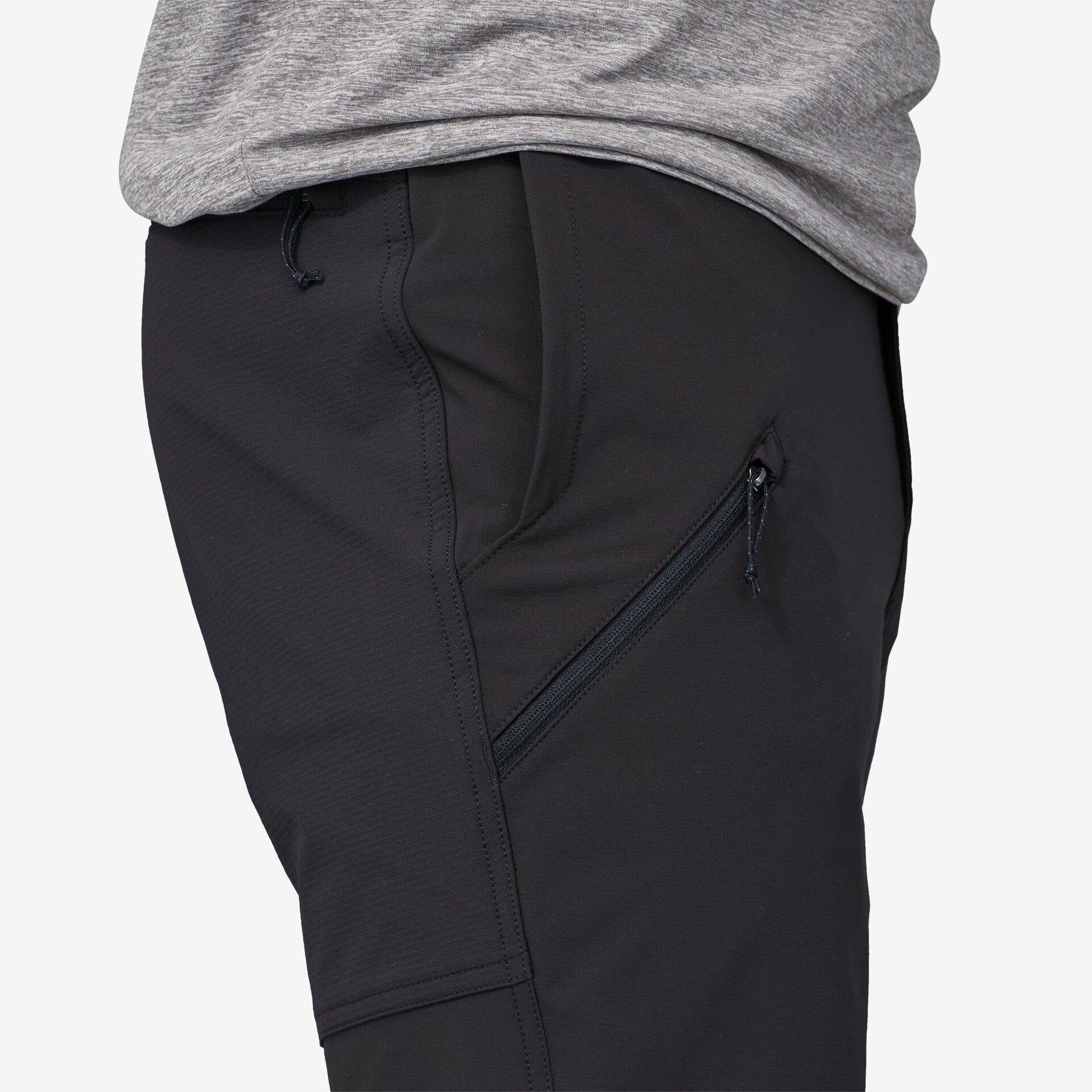 Close-up of black Patagonia Point Peak Trail Pants showing side zipper pocket detail