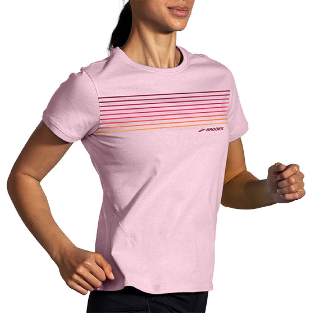 Woman wearing Brooks Distance short sleeve running shirt in quartz pink with gradient stripes