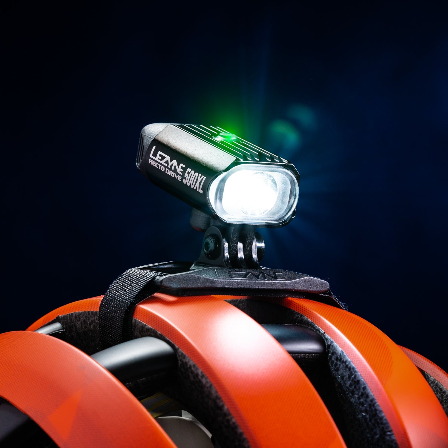 Lezyne Hecto Drive 500XL bike light mounted on orange cycling helmet