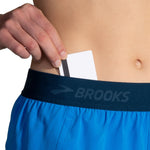 Brooks Chaser 3-inch running shorts in azure blue with hidden waistband pocket holding a card