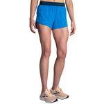 Brooks Chaser 3-inch running shorts in azure blue with branded elastic waistband on female model