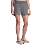 Brooks Chaser 7-inch women's running shorts in heather charcoal gray with sneakers