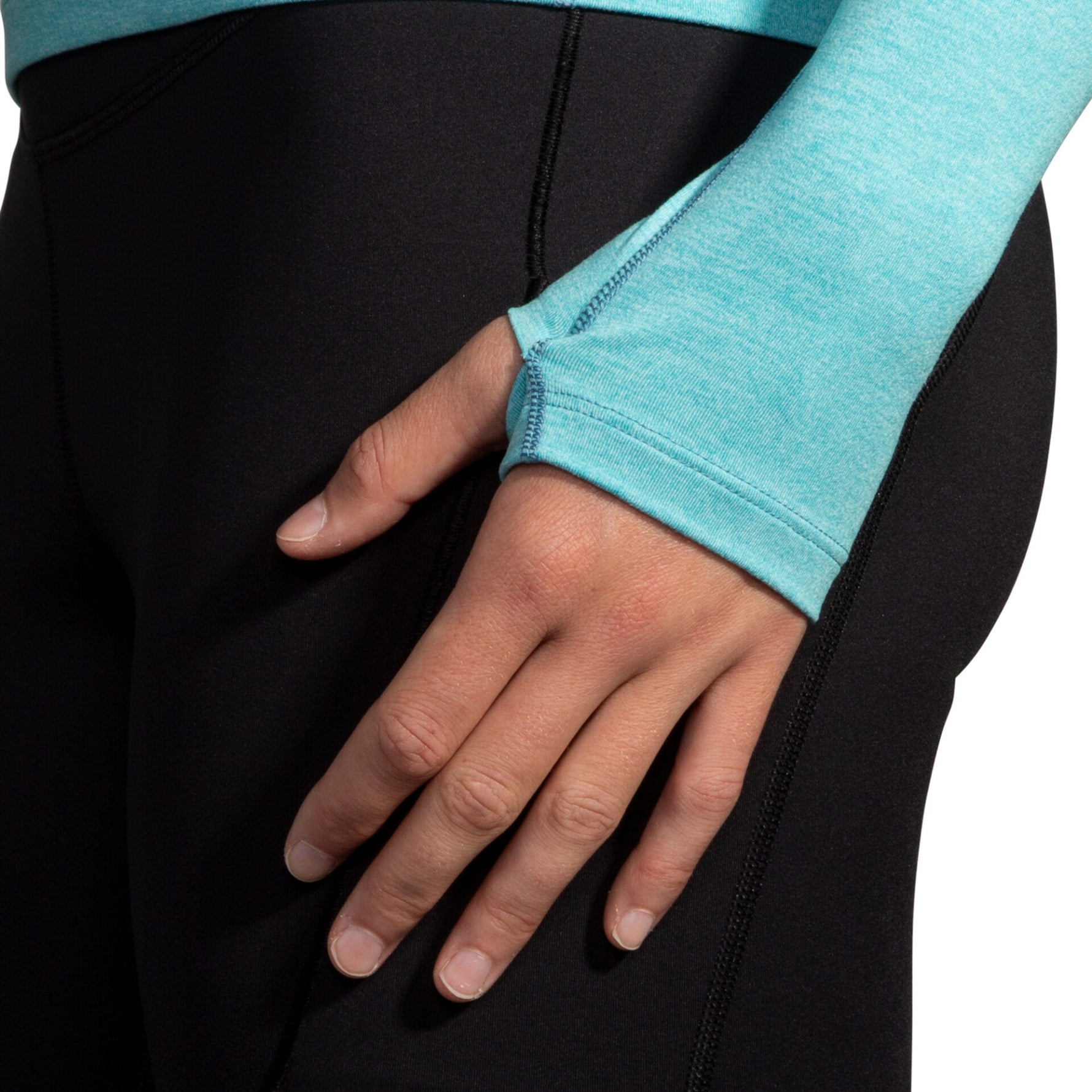 Close-up of Brooks Dash 1/2 Zip 2.0 sleeve cuff in heathered aqua with black leggings