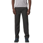 Man wearing Patagonia Quandary pants in tent green with hiking shoes