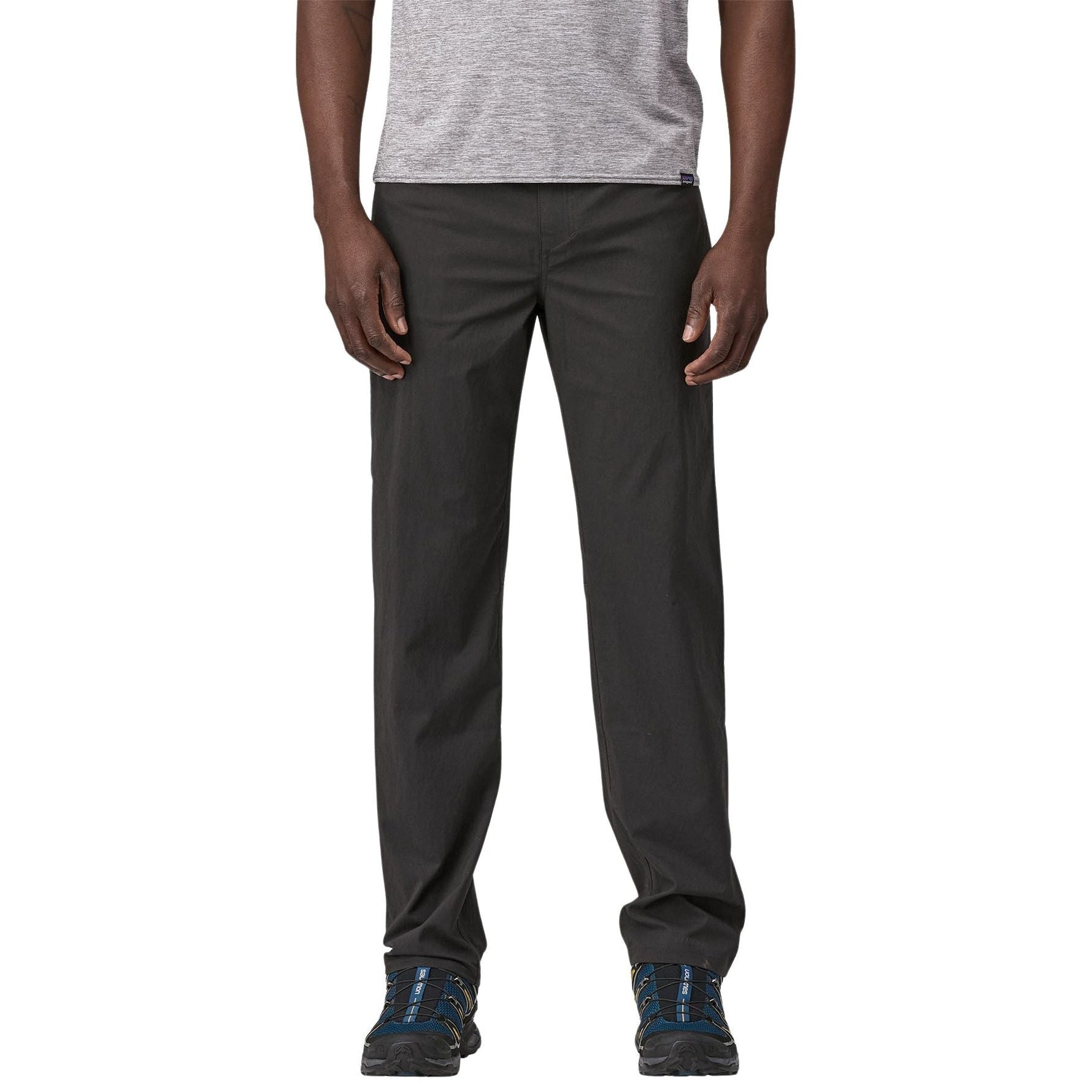 Man wearing Patagonia Quandary pants in tent green with hiking shoes