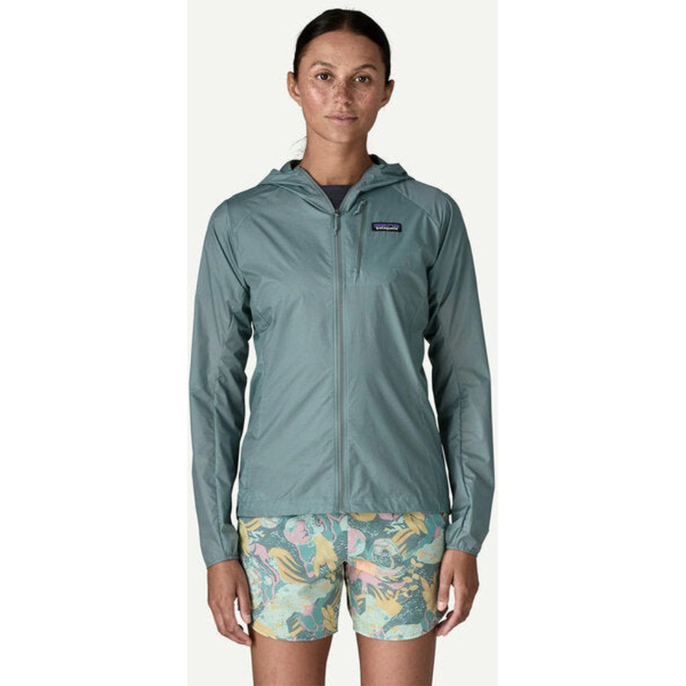 Woman wearing Patagonia Houdini Jacket in Blue Sage color with hood up