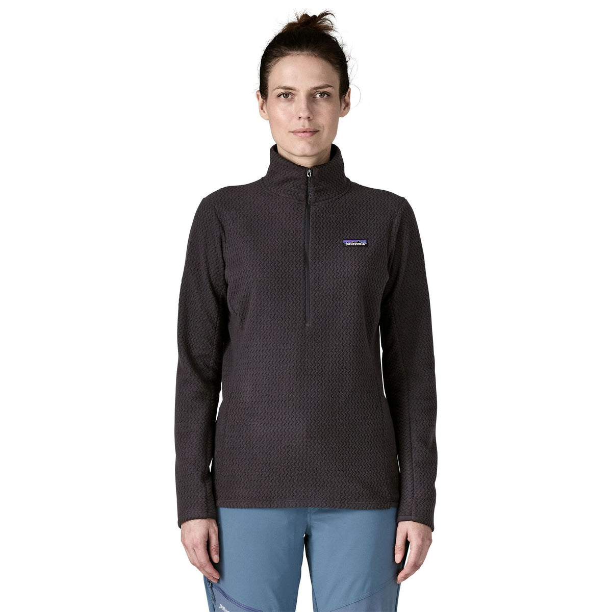 Front close-up of woman modeling black Patagonia R1 Air Fleece Zip-Neck with zigzag texture