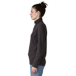 Side profile view of woman wearing black Patagonia R1 Air Fleece Zip-Neck showing slim fit